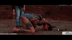 Ass eating bondage slave cries while her feet get caned outdoors in the dirt - Rocky Emerson Thumb
